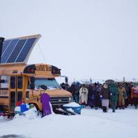 A procession makes its way down to the Cannonball River to take part in a Native American water ceremony at the Oceti Sakowin camp where people have gathered to protest the Dakota Access oil pipeline in Cannon Ball, North Dakota, Thursday. | AP