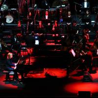 Classic concert: Yoshiki sits at a piano and performs with Katie Fitzgerald of Violet UK, a Yoshiki side project. | KAZUAKI NAGATA