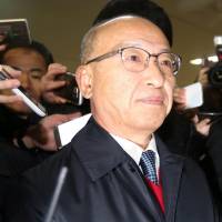 Former South Korean Health Minister Moon Hyung-pyo arrives at the office of the independent counsel in Seoul on Dec. 27. South Korean pension fund chief arrested as part of corruption probe