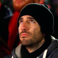 Or Elyakim, the son of Dalia Elyakim, the Israeli victim in last week\'s Christmas market attack, attends the lighting ceremony of Europe\'s largest Hanukkah menorah at the Brandenburg Gate in Berlin Tuesday. | REUTERS