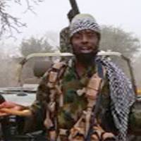 This screen grab image taken Thursday from a video released on YouTube by Islamist group Boko Haram shows Boko Haram leader Abubakar Shekau making a statement at an undisclosed location. The embattled leader, Abubakar Shekau, appeared in a new video disputing a claim by Nigerian President Muhammadu Buhari that the jihadi group had been routed from its Sambisa Forest stronghold. \"We are safe. We have not been flushed out of anywhere. And tactics and strategies cannot reveal our location except if Allah wills by his decree,\" Shekau said in the 25-minute video, flanked by armed fighters. | BOKO HARAM / AFP-JIJI