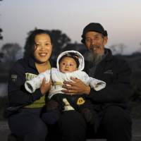 A Chinese couple pose with their son, their only child, in December 2013, before China eased family planning restrictions to allow couples to have two children. | REUTERS