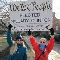 Cheryl Kreiser (right) and Krista Keyes demonstrate in front of the Maryland State House in Annapolis Monday hours before Maryland’s 10 electors were scheduled to cast the state’s electoral votes for Hillary Clinton. U.S. judge orders unsealing of application for Clinton email search warrant