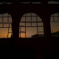 The night sky is seen through damaged windows in the rebel-controlled town of Binnish in Idlib province, Syria, on Sept. 7, 2016. | REUTERS