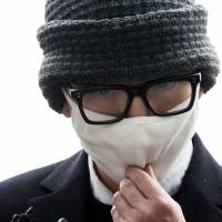 The man who disrupted a Korean Air flight last week arrives at Incheon Airport\'s police station Monday in South Korea. | REUTERS