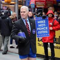 Glenn Pannell, known as \"Mike Hot-Pence,\" a look-alike for Vice President-elect Mike Pence, takes a collection for causes, including LGBT rights, in Times Square, New York, Dec. 3. | COURTESY HOWARD SHERMAN/HANDOUT VIA REUTERS