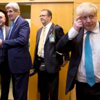 British Foreign Secretary Boris Johnson (right) attends a NATO foreign ministers meeting at the Alliance headquarters in Brussels on Tuesday, with U.S. Secretary of State John Kerry (second from left) and Turkish Foreign Minister Mevlut Cavusoglu (left) standing nearby. British Prime Minister Theresa May was on Thursday forced to issue a clarification over recent comments Johnson made about the Middle East. | POOL / VIA REUTERS