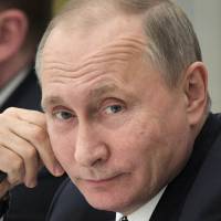 Russian President Vladimir Putin attends a meeting with Russian businessmen at the Kremlin in Moscow on Monday. | AP