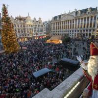 St. Nicholas waves to the crowd from the balcony of Brussels\' Grand Place during a traditional parade on Saturday. | REUTERS
