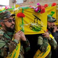 Mourners carry the coffins of four militia members of a Shiite group, the Nujaba movement of Islamic Resistance, in the Shiite holy city of Najaf in Iraq in December 2015. | AP