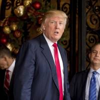 President-elect Donald Trump (center), accompanied by Trump Chief of Staff Reince Priebus (right) and retired Gen. Michael Flynn, a senior adviser to Trump, speaks to members of the media at Mar-a-Lago, in Palm Beach, Florida, Wednesday. | AP