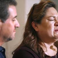 Aida Sandoval, holds back tears as she and her husband, Arturo Sandoval, address the media following surgery on their twin daughters at the Lucile Packard Children\'s Hospital Thursday in Palo Alto, California. | AP