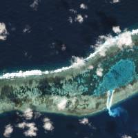 Sand can be seen spilling from a newly dredged channel in this view of Vietnamese-held Ladd Reef, in the Spratly Island group in the South China Sea, Nov. 30in this Planet Labs handout photo received by Reuters on Tuesday. Vietnam dredging at disputed Spratly reef in South China Sea: Reuters