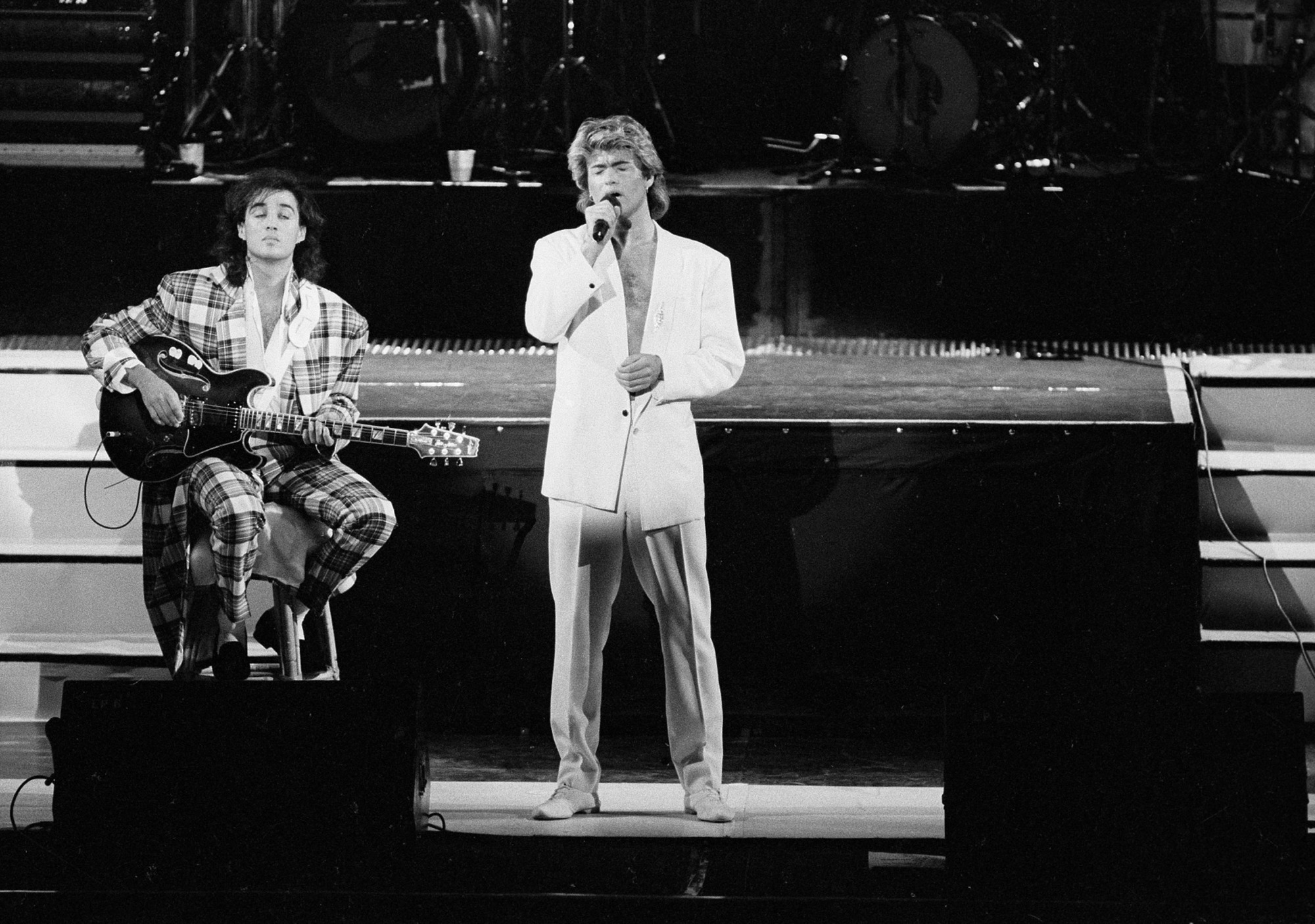 George Michael and Andrew Ridgeley of the British duo Wham! perform in Beijing on April 7, 1985. | AP