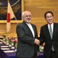 Iran\'s Foreign Minister Mohammad Javad Zarif shakes hands with his Japanese counterpart Fumio Kishida at their talks Wednesday in Tokyo. | AFP-JIJI