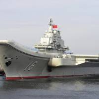 China\'s first aircraft carrier, the Liaoning, is shown berthed in an unnamed Chinese port in this undated file photo from China\'s official Xinhua News Agency. | AP