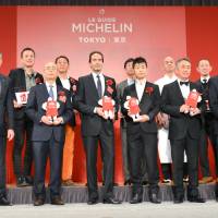 Jiro Ono (front row, second from left), a sushi chef at Sukiyabashi Jiro, and other restaurant owners and chefs given stars on Michelin Guide Tokyo 2017 are awarded at a Tokyo hotel on Tuesday. | KYODO
