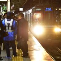 A man was arrested Tuesday on suspicion of trying to kill a woman by pushing her on a train platform at JR Sannomiya Station in Kobe. | KYODO