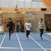 From left: Paralympic track athlete Keita Sato, real estate company Tokyo Tatemono executive Hisao Shibayama, former Olympic hurdler Dai Tamesue and president of prosthetics developer Xiborg, Ken Endo, participate in an exhibition run at the new Shin-Toyosu Brillia Running Stadium during its opening reception Friday. | KAZ NAGATSUKA