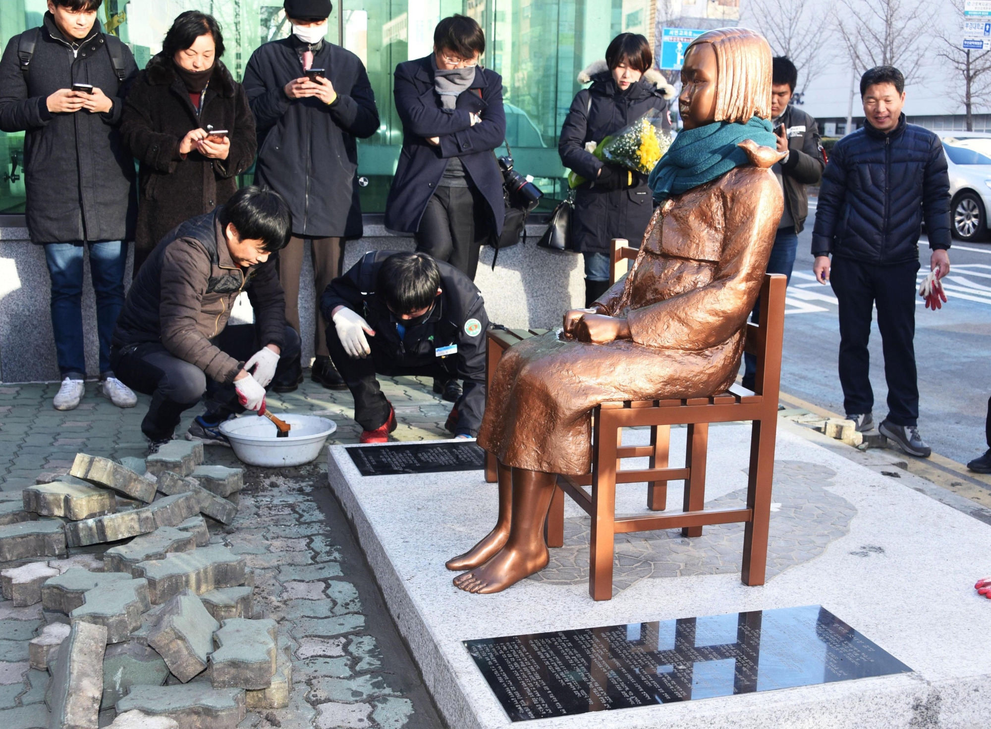 A statue symbolizing Korean 'comfort women' sits in front of the Japanese Consulate in Busan on Friday. | KYODO