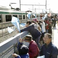Local people attend the reopening ceremony for the new station in Shinchi, Fukushima Prefecture, on Saturday. The station on the Joban Line is on a section of line hardest hit by the 2011 Great East Japan Earthquake. | KYODO