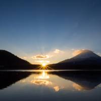 A new dawn: The sun rises by Mount Fuji one early morning in Japan. | ISTOCK