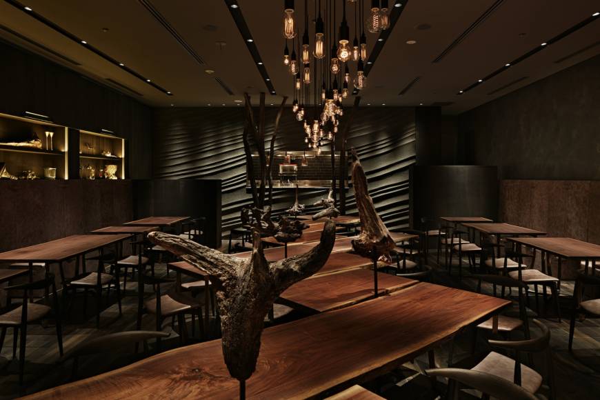 Argile Earthy interior: Argile's dining room is dark, atmospheric and fitted out with natural materials, including suspended pieces of worn tree trunks. | ESQUISSE