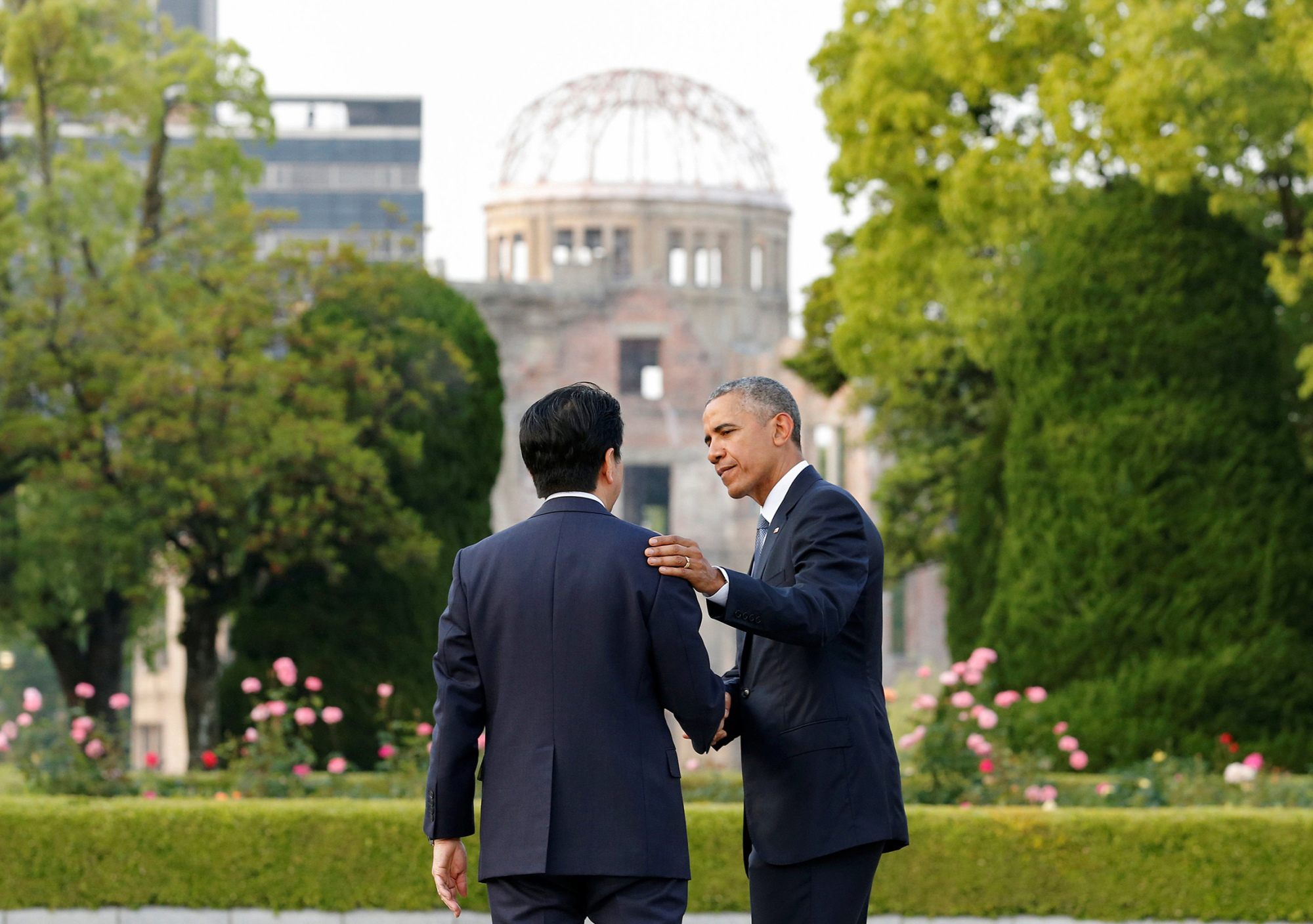 Clockwise from left: U.S. President Barack Obama confers with Prime Minister Shinzo Abe at Hiroshima Peace Memorial Park on May 27. Obama hugs atomic bomb survivor Shigeaki Mori. Survivor Hiroshi Harada speaks ahead of Obama's visit. | REUTERS