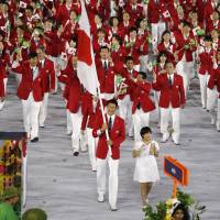 Flagbearer Keisuke Ushiro leads the Japan contingent during the opening ceremony of the Summer Olympics in Rio de Janeiro. | REUTERS