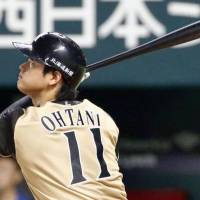 Fighters pitcher Shohei Otani hits a leadoff homer against the Hawks. | KYODO