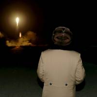North Korean leader Kim Jong Un watches a ballistic rocket launch at an unknown location in an undated photo released in March. | REUTERS