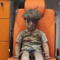 Five-year-old Omran Daqneesh sits in an ambulance after he was rescued following an airstrike on his home in Aleppo, Syria. | REUTERS