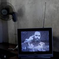 A TV broadcasts black-and-white footage of Fidel Castro at a memorial on the outskirts of Havana. | AP
