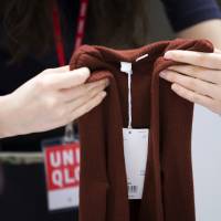 Exploited workers?: An employee folds clothing in a Uniqlo store. | TOMOHIRO OHSUMI / BLOOMBERG