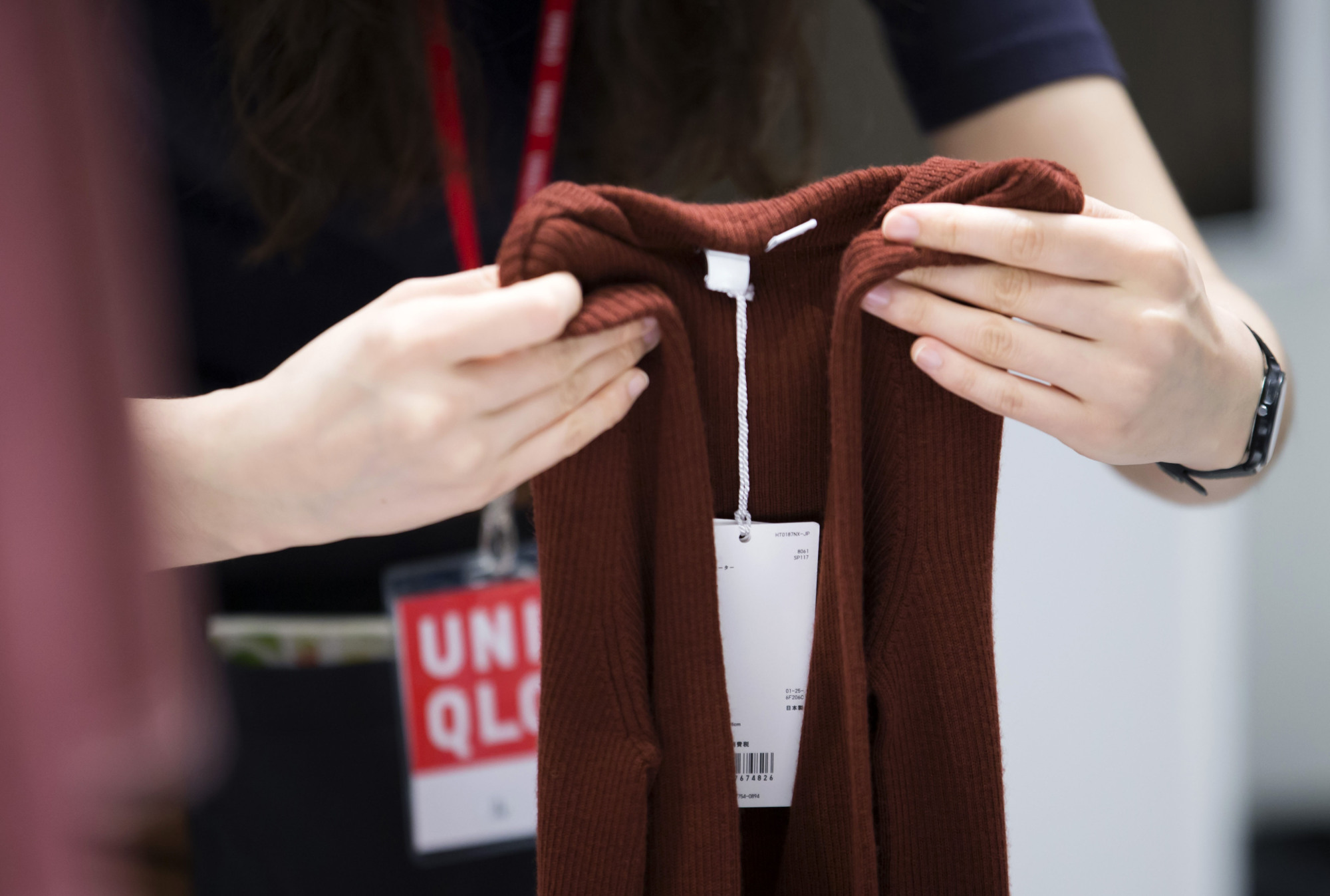 Exploited workers?: An employee folds clothing in a Uniqlo store. | TOMOHIRO OHSUMI / BLOOMBERG