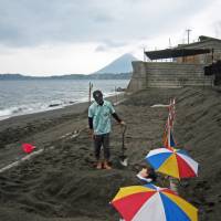 Buried alive: A customer is covered in sand at Yamakawa Tsunamushi Onsen Sayuri. Buried alive in the shadow of a Kyushu volcano