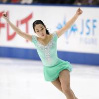Third-place finisher Mai Mihara skates in Sunday\'s free competition at the national championships. | KYODO