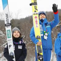 Winner Yuki Ito (right) and runnerup Sara Takanashi stand on the podium after the Yoshida Cup on Sunday in Nayoro, Hokkaido | KYODO