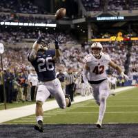 Penn State\'s Saquon Barkley, seen making an 18-yard touchdown catch against Wisconsin\'s T.J. Watt  in the second half of the Big Ten championship last Saturday, and his Nittany Lions teammates are not participating in the four-team College Football Playoff this season. At 10-2, Penn State deserves a shot at competing in the national tournament. | AP