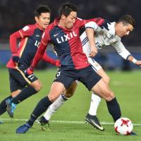 Kashima Antlers defender Gen Shoji (center) competes for the ball with Real Madrid’s Cristiano Ronaldo during the Club World Cup final in Yokohama on Dec. 18. Japan may have to wait for more Club World Cup heroics