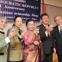 Somsanouk Vongsack (center), charge d\'Affaires a.i. of Laos raises her glass with (from left) Takako Ito, assistant chief of protocol, director of the Ministry of Foreign Affairs Protocol Office; Shinako Tsuchiya, chairman of the Japan-Laos Parliamentary Friendship League; Kazuya Nashida, director general of the Ministry of Foreign Affairs Southeast and Southwest Asia Affairs Department; and Itsuo Hashimoto, Japan-Laos Association president, during a reception celebrating the 41st national day anniversary of the Lao People\'s Democratic Republic at the embassy in Tokyo on Dec. 4. | YOSHIAKI MIURA