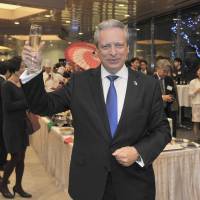 European Union Ambassador Viorel Isticioaia-Budura, raises a glass during a year-end party  at Europa House in Tokyo on Dec. 2. | YOSHIAKI MIURA