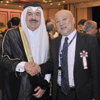 Qatar\'s Ambassador Yousef Mohamed Bilal (left) greets the Ministry of Foreign Affairs Director-General of the Middle Eastern and African Affairs Bureau Tsukasa Uemura at a reception to celebrate the National Day of the State of Qatar at the Imperial Hotel, Tokyo, on Dec. 13. | YOSHIAKI MIURA