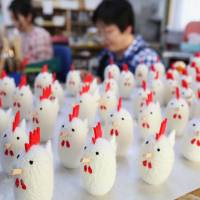 Workers at the Murata Folk Craft Workshop in Iwate Prefecture make rooster crafts from silkworm cocoons Wednesday ahead of the Year of the Rooster in 2017. The workshop has been making zodiac symbol cocoon crafts for 30 years. | KYODO