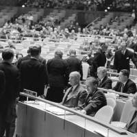 U.N. Chief of Protocol Jehan De Noue shows members of Japan\'s delegation to their seats at the U.N. headquarters in New York on Dec. 18, 1956. | UN PHOTO / AF