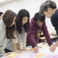 Japanese and Southeast Asian students work together in class as part of the Sophia-ASEAN International Mobility for Students, or SAIMS, program. | MASANORI DOI
