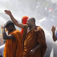 Sri Lankan police use water cannon to disperse monks and villagers protesting outside the inauguration ceremony of an industrial zone in Mirijjawila village in Ambalantota, Sri Lanka, Saturday. | AP