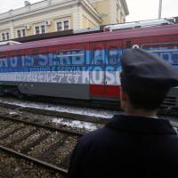 A railroad worker stands by the first train decorated with letters that read “Kosovo is Serbian” written in twenty languages departing from Belgrade to Mitrovica, Kosovo, at Belgrade’s railway station, Serbia, Saturday. Serbia has launched a railway link to Serb-dominated northern Kosovo despite protests from authorities in Pristina who described the move as a provocation and an aggressive violation of Kosovo’s sovereignty. Serb nationalist train denied Kosovo entry seen threatening armed clash, West-Russia row over Balkans