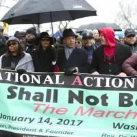 The Rev. Al Sharpton (center, in hat) and civil rights advocates march to honor the Rev. Martin Luther King Jr. in Washington on Saturday | AP