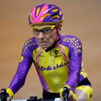 French cyclist Robert Marchand, 105, rides on his way to cover 22.528 km (14.08 miles) in one hour to set a new record at the indoor Velodrome National in Montigny-les-Bretonneux, southwest of Paris Wednesday. | REUTERS